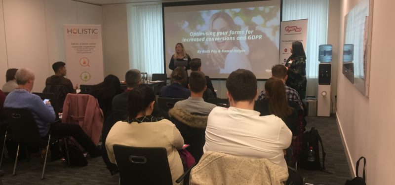 Group of people gathered and listening to a presentation