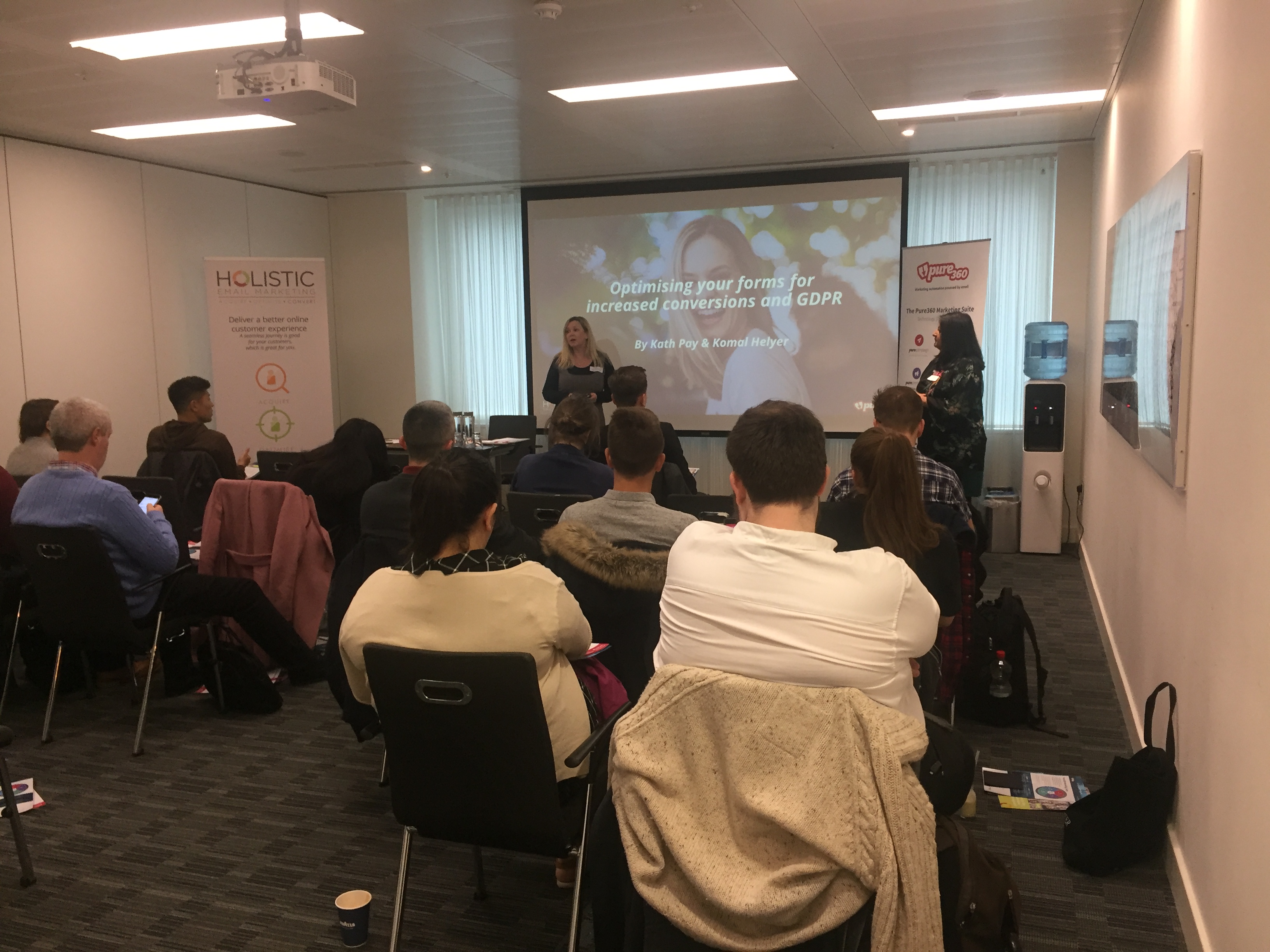 Group of people gathered and listening to a presentation