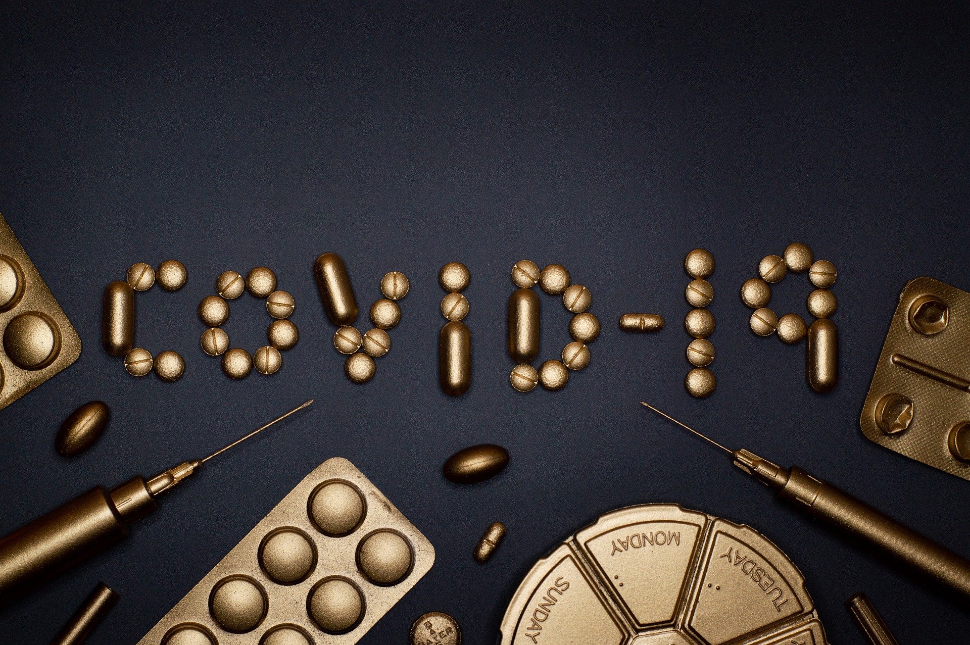 covid-19 written out in golden pills