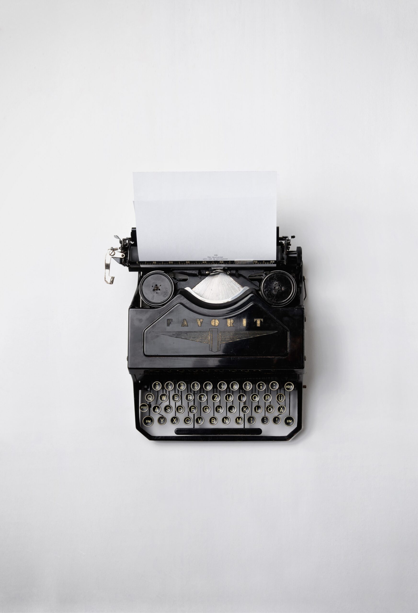 Does your email copy persuade or sell? black typewriter on white background