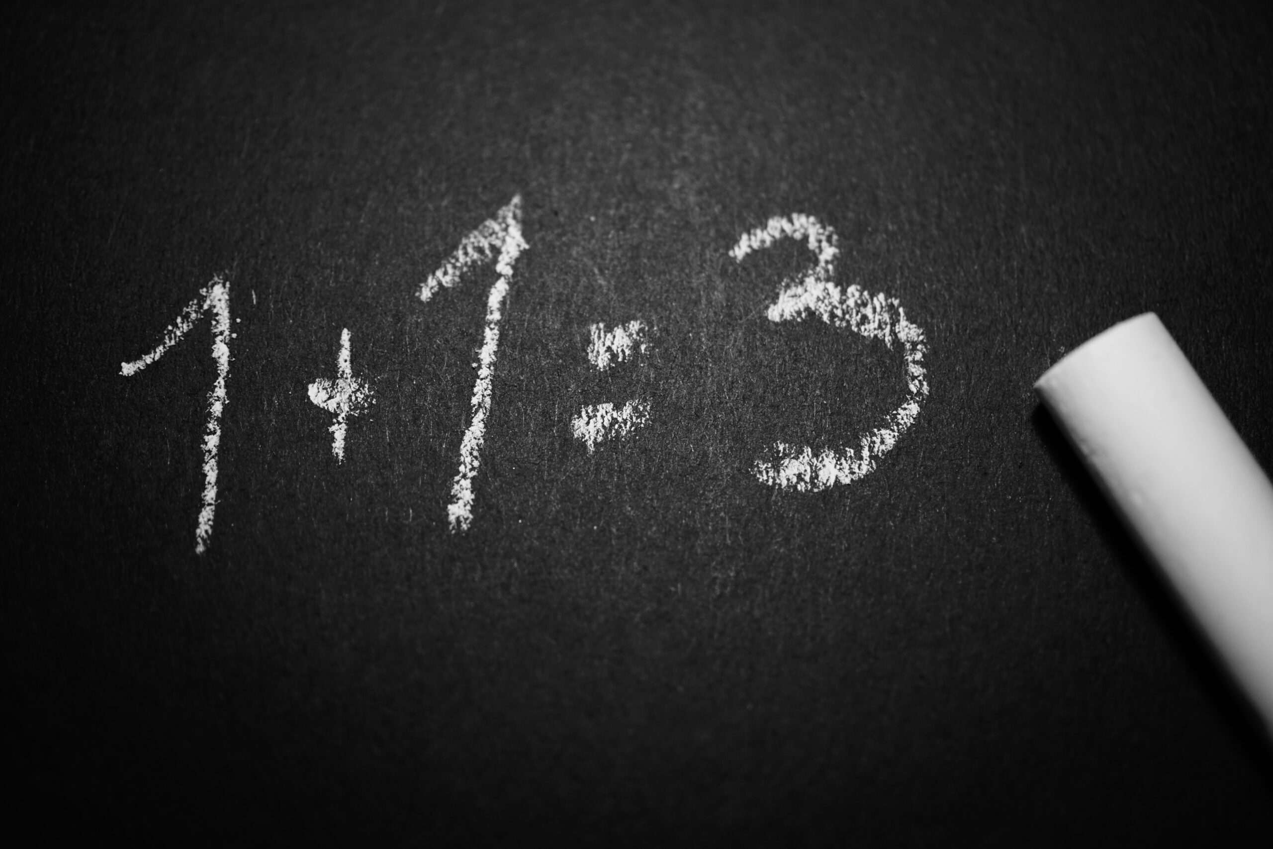 four common mistakes holding back your email success - chalk on blackboard with 1 + 1 = 3