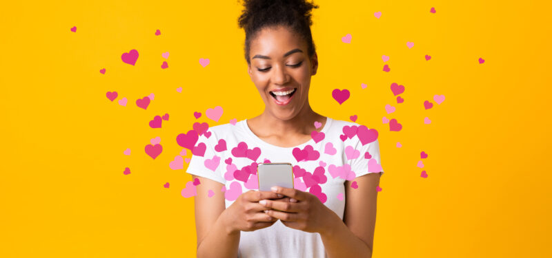 woman looking at phone with hearts coming out - 4 emails that customers will love