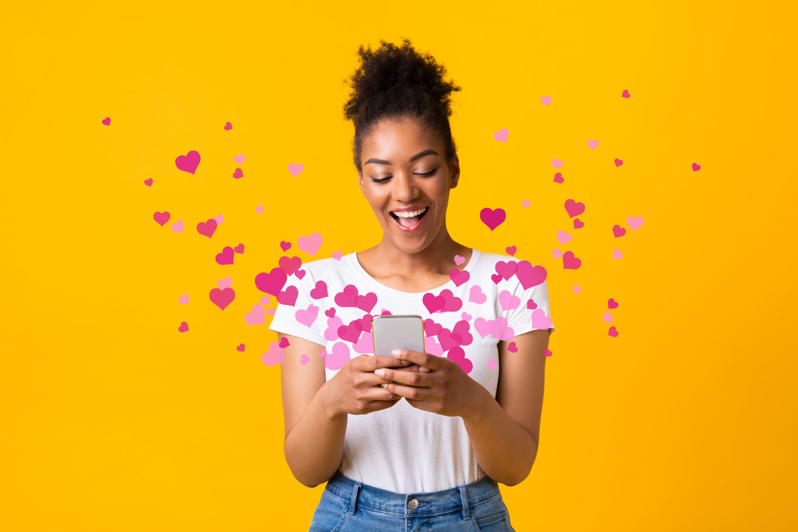 woman looking at phone with hearts coming out - 4 emails that customers will love